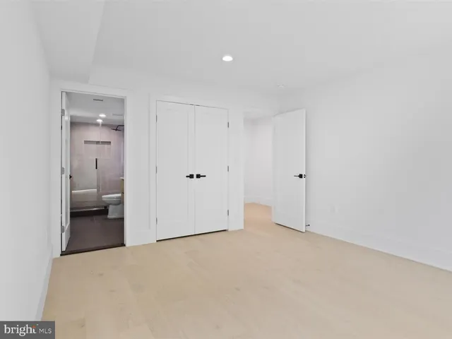 a bathroom with a toilet a sink and a mirror