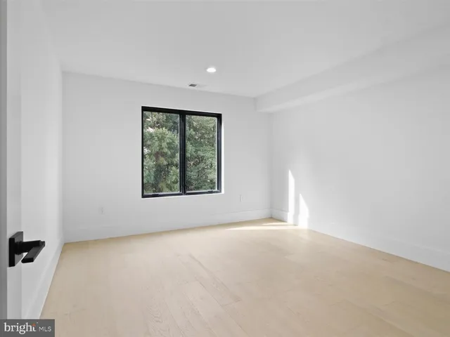 a bathroom with a double vanity sink toilet and mirror