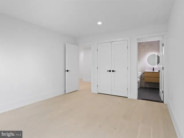 a bathroom with a sink a toilet a mirror and shower