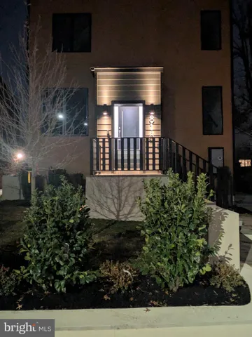 a kitchen with stainless steel appliances a table chairs refrigerator and cabinets