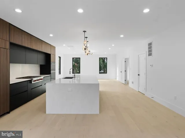 a kitchen with a sink a counter and chairs