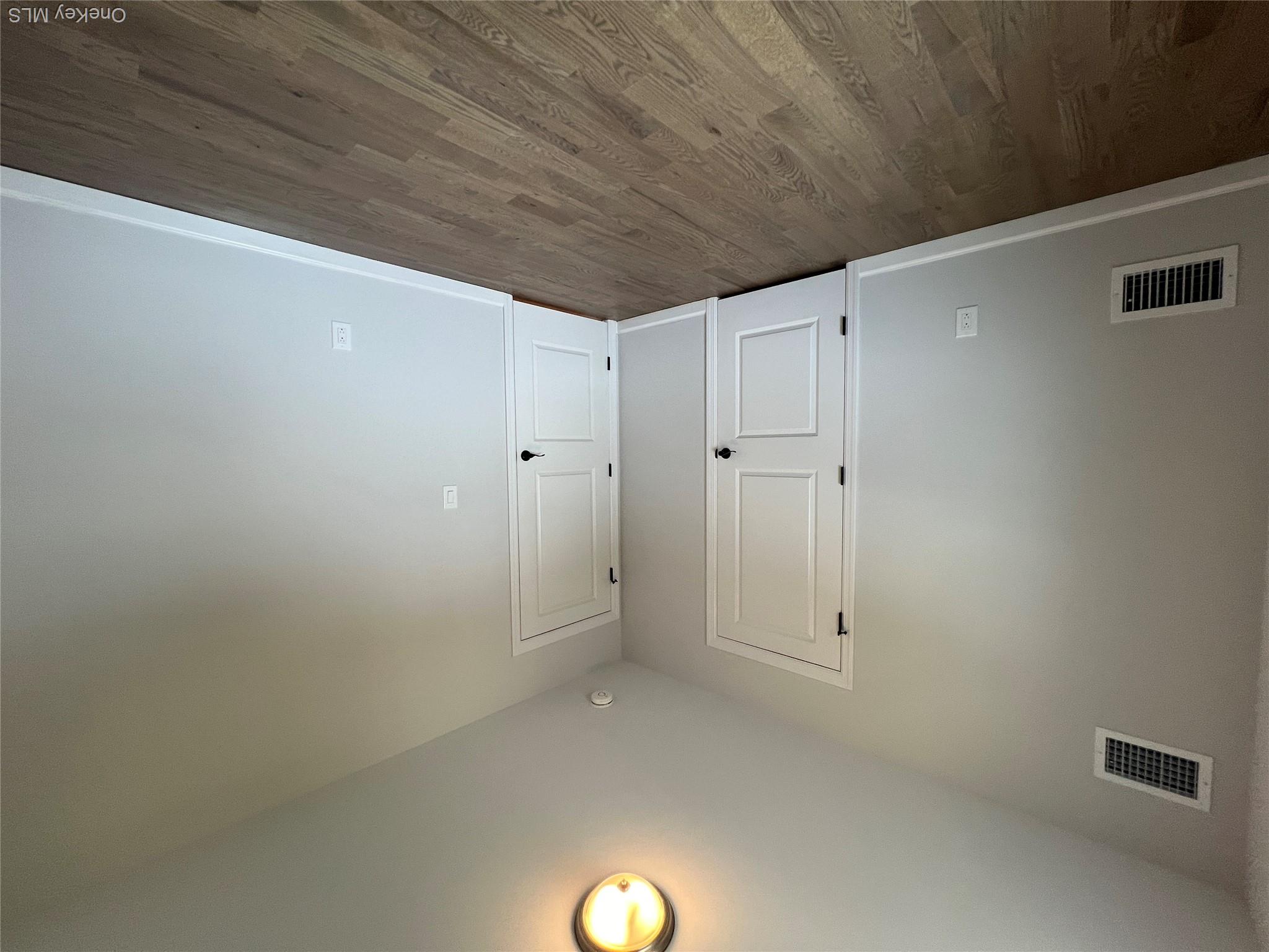 35 Babylon Road Mastic Beach, NY 11951 - Photo 12 of 19 a view of an empty room with wooden floor and windows