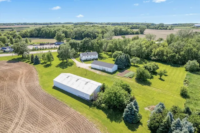 an aerial view of a house with yard swimming pool and outdoor seating