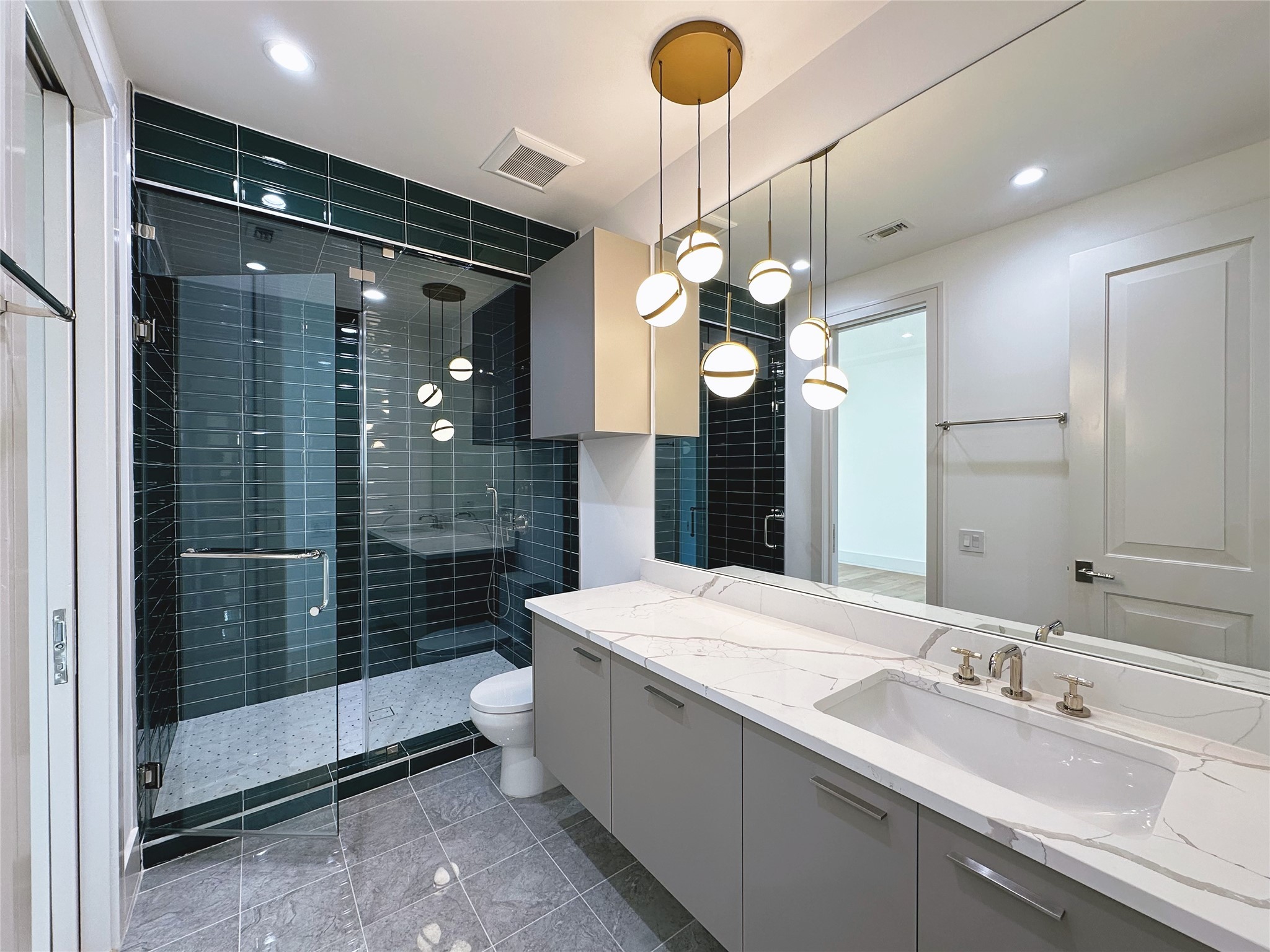 3818 Drake Street Houston, TX 77005 - Photo 21 of 31 a bathroom with a sink a light fixture and a glass door shower