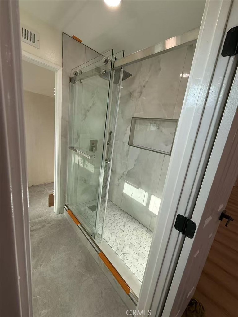 9894 Spruce Court Cypress, CA 90630 - Photo 12 of 22 a bathroom with a glass door shower