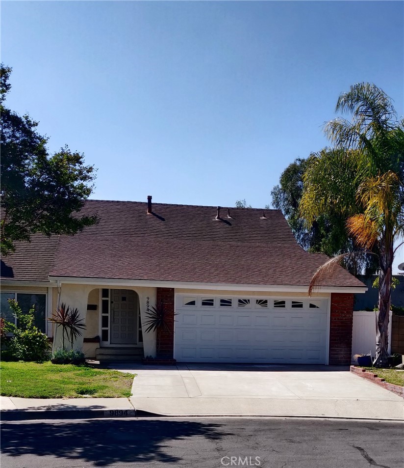 9894 Spruce Court Cypress, CA 90630 - Photo 2 of 22 a front view of a house with yard