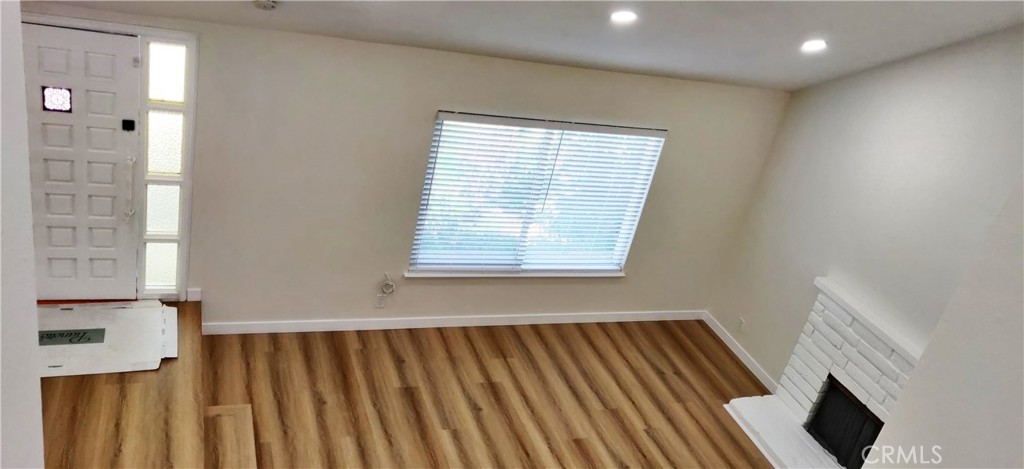 9894 Spruce Court Cypress, CA 90630 - Photo 3 of 22 an entryway with wooden floor and windows