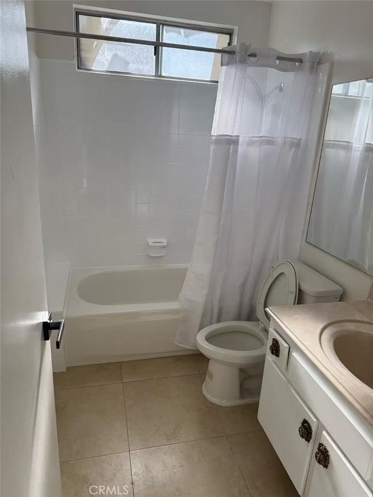 9894 Spruce Court Cypress, CA 90630 - Photo 8 of 22 a white toilet sitting next to a bath tub