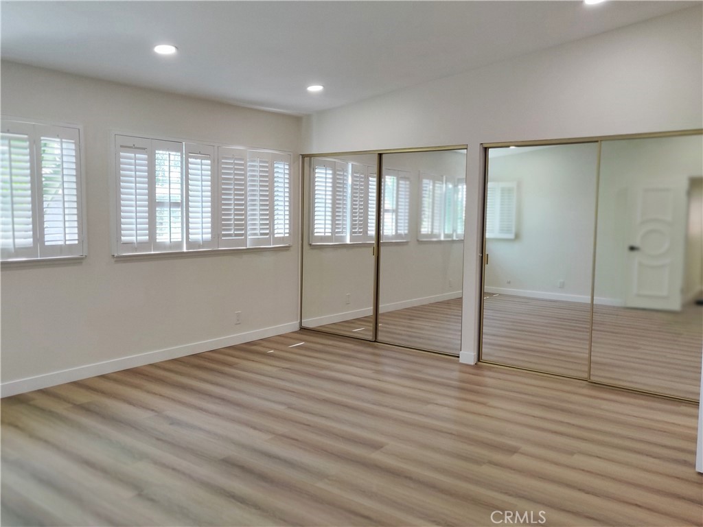 9894 Spruce Court Cypress, CA 90630 - Photo 10 of 22 a view of an empty room with wooden floor and a window