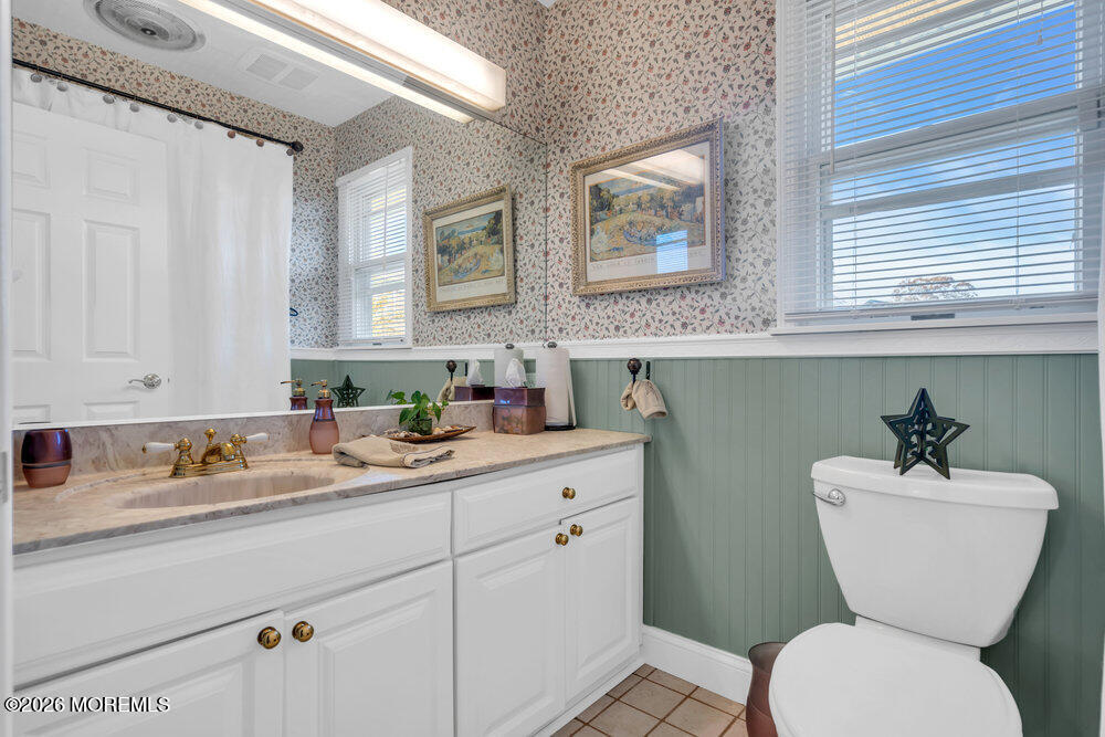 2111 Middle Avenue Point Pleasant, NJ 08742 - Photo 27 of 51 a bathroom with a toilet a sink and mirror