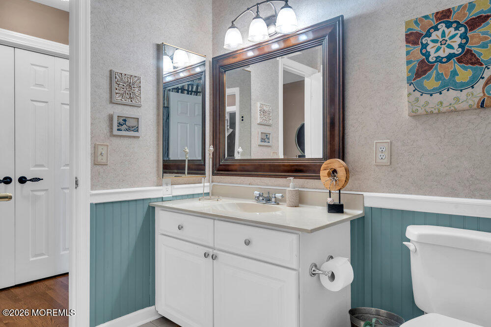 2111 Middle Avenue Point Pleasant, NJ 08742 - Photo 29 of 51 a bathroom with a sink a toilet and a mirror