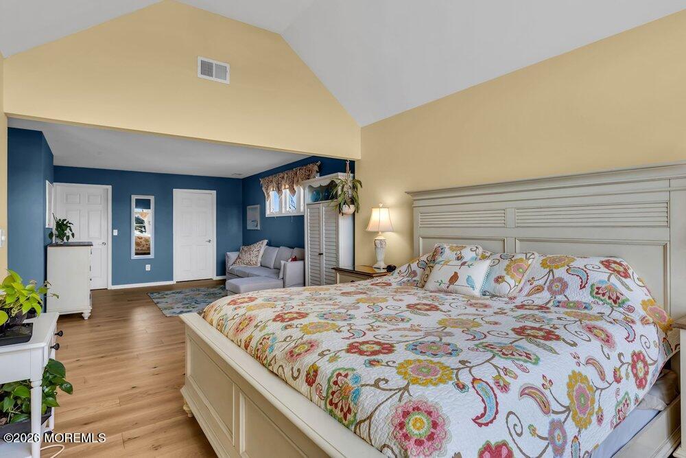 2111 Middle Avenue Point Pleasant, NJ 08742 - Photo 36 of 51 a bedroom with a large bed and a chandelier