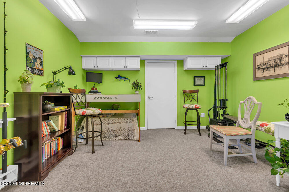 2111 Middle Avenue Point Pleasant, NJ 08742 - Photo 42 of 51 a living room with furniture and a bookshelf