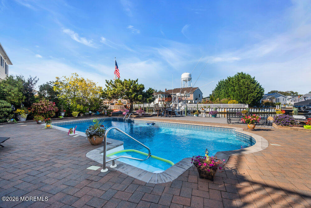 2111 Middle Avenue Point Pleasant, NJ 08742 - Photo 45 of 51 a swimming pool with outdoor seating and yard in the back