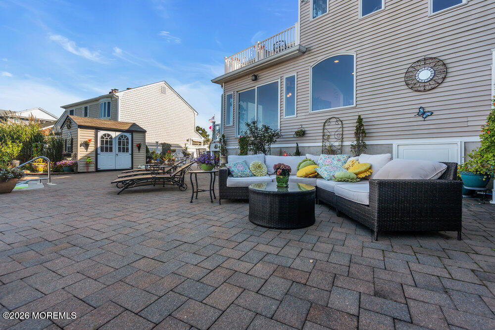 2111 Middle Avenue Point Pleasant, NJ 08742 - Photo 46 of 51 a view of a patio with dining table and chairs with a potted plants