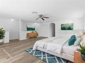 a bedroom with a large bed and a chandelier