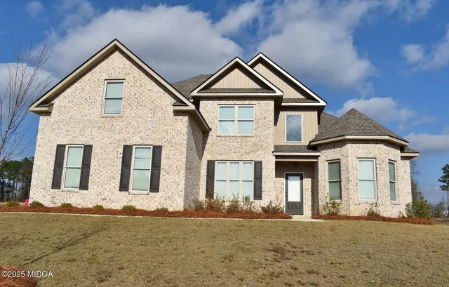 a front view of a house with a yard