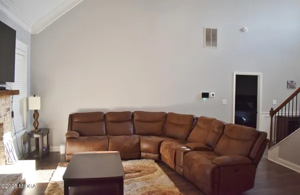 a living room with furniture a couch and a flat screen tv