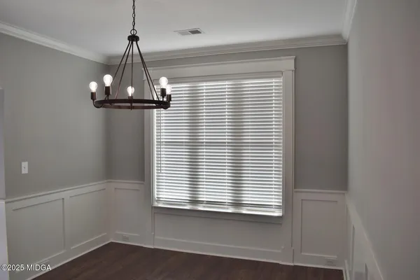 a view of a room with a window and wooden floor