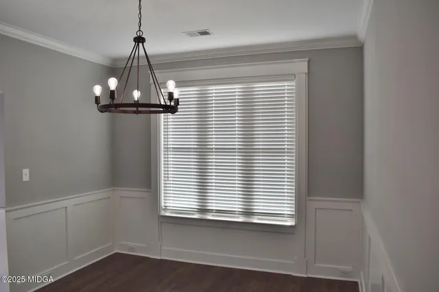 a view of a room with a window and wooden floor