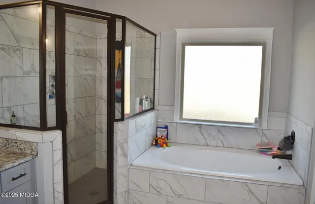 a bathroom with a tub and shower