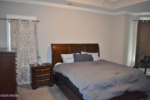 a bedroom with a bed and a dresser