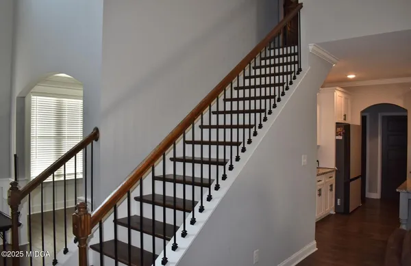 a view of entryway with wooden floor and stairs