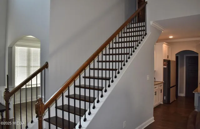 a view of entryway with wooden floor and stairs