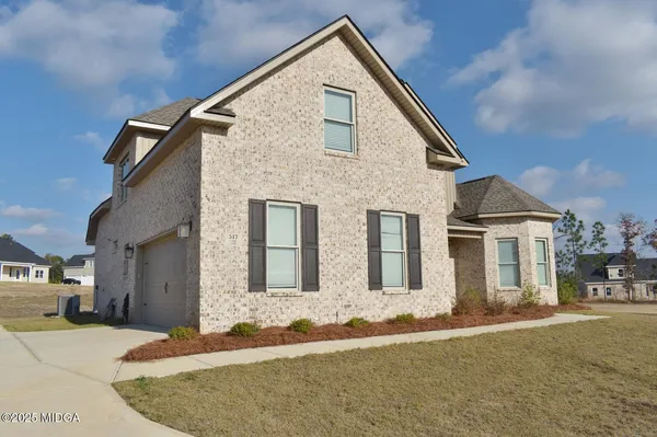 a front view of a house with a yard
