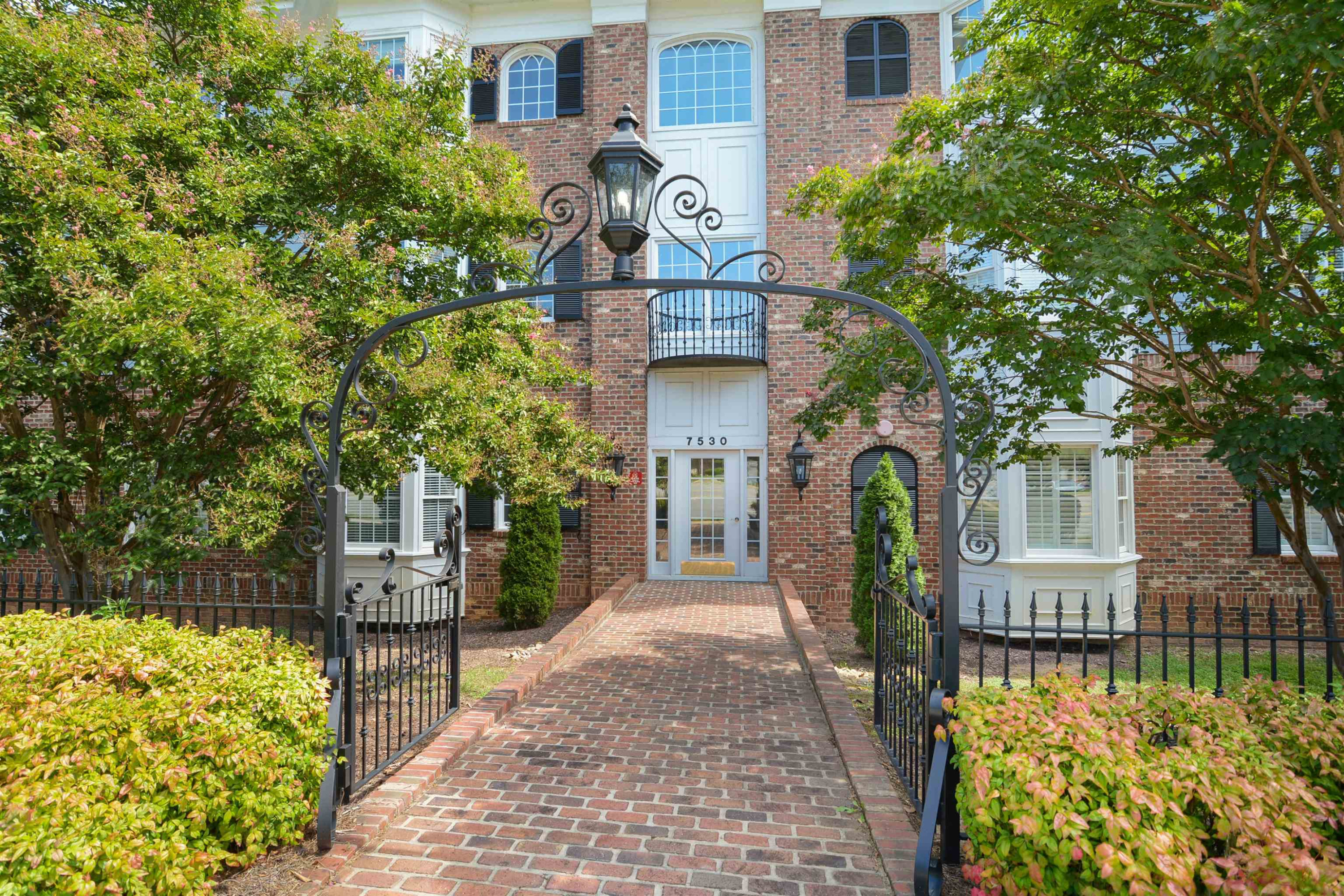 7530 Lead Mine Road, Unit 206 Raleigh, NC 27615 - Photo 1 of 19 a front view of a house with a garden