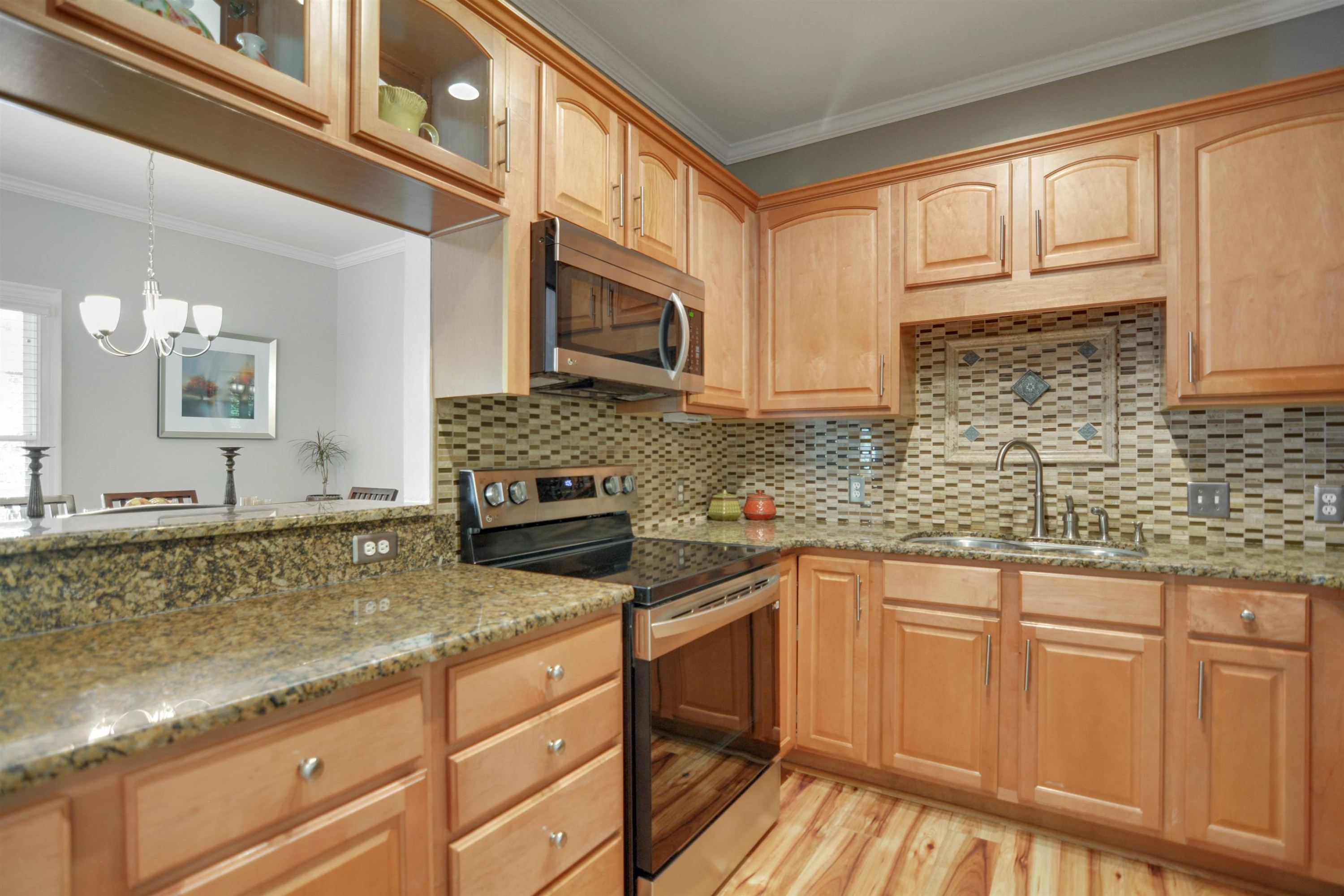 7530 Lead Mine Road, Unit 206 Raleigh, NC 27615 - Photo 7 of 19 a kitchen with stainless steel appliances granite countertop a sink stove and cabinets