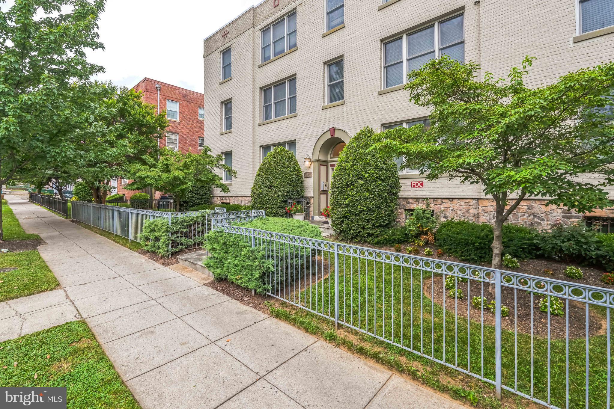 5040 1st Street Northwest, Unit 301 Washington, DC 20011 - Photo 13 of 22 a front view of a house with a garden