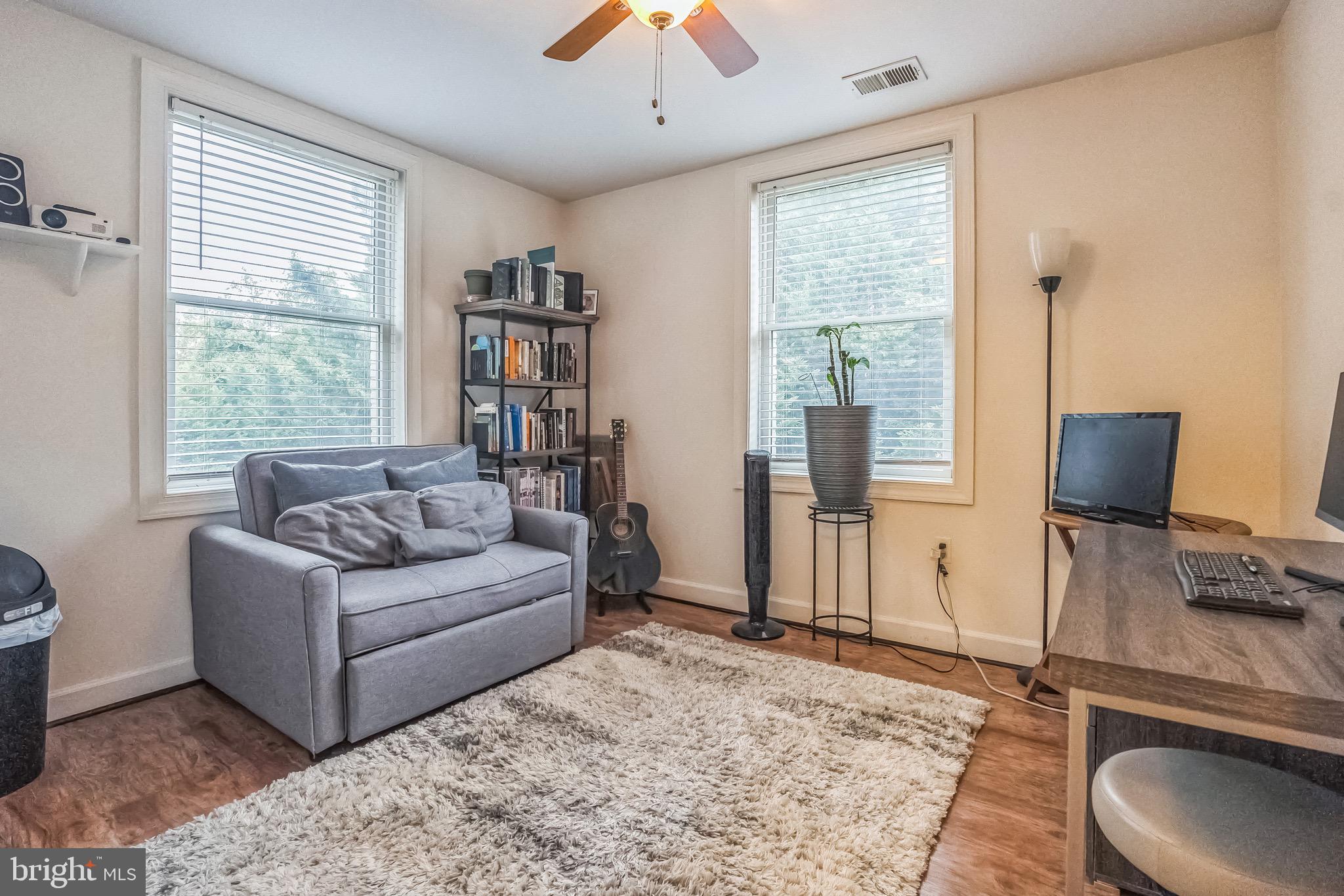 5040 1st Street Northwest, Unit 301 Washington, DC 20011 - Photo 9 of 22 a living room with furniture and a flat screen tv