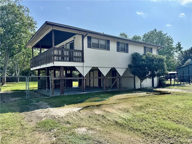 a view of a house with swimming pool and porch