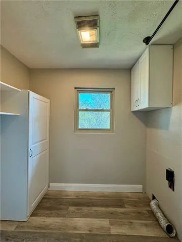 a view of storage and utility room with wooden floor