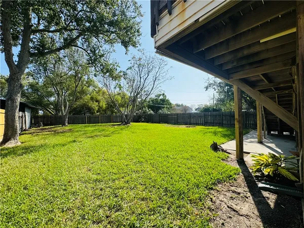 a view of a backyard with swimming pool