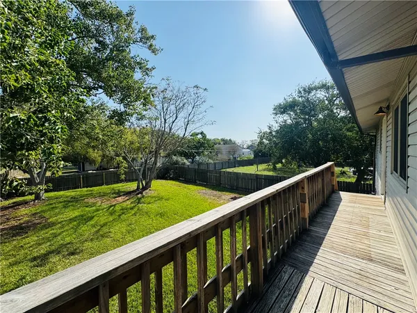 a view of a balcony with wooden floor