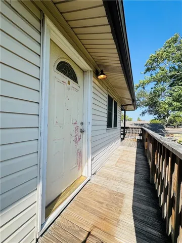 a view of a porch with wooden floor and stairs