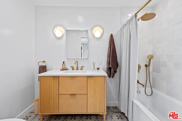 a bathroom with a sink and mirror