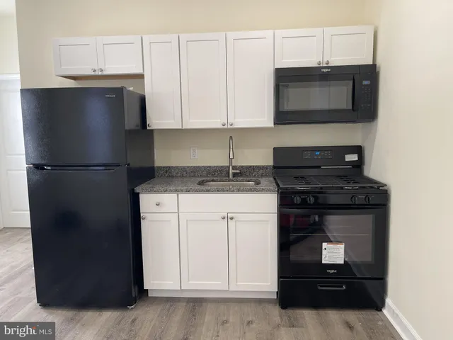 a kitchen with a refrigerator stove and microwave