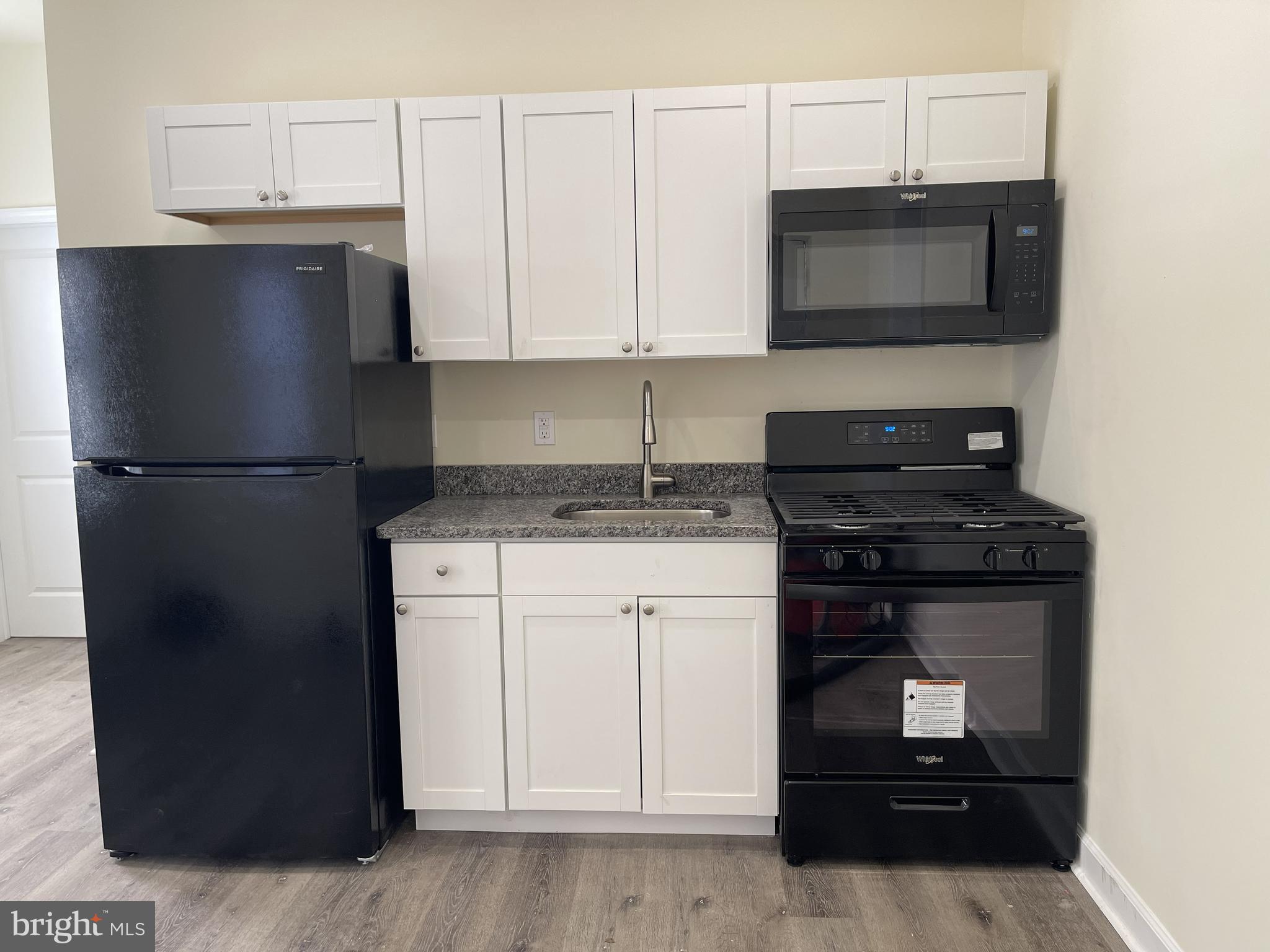 a kitchen with a refrigerator stove and microwave