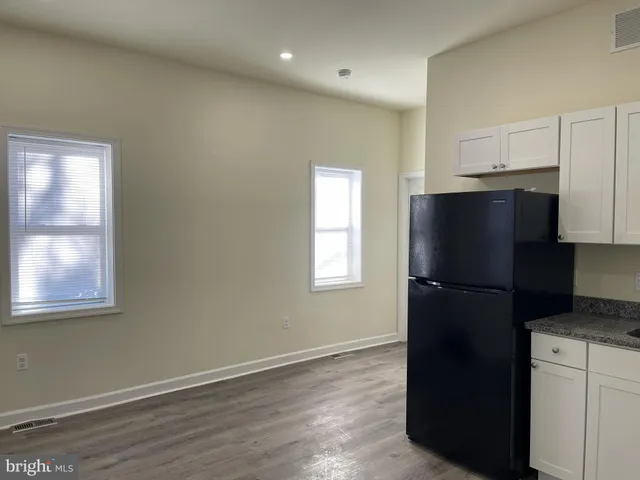 a view of a kitchen with a refrigerator and window