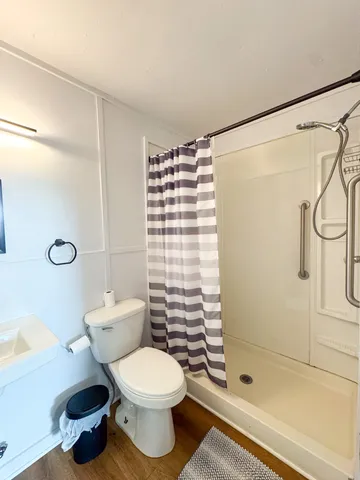 a bathroom with a toilet and a shower