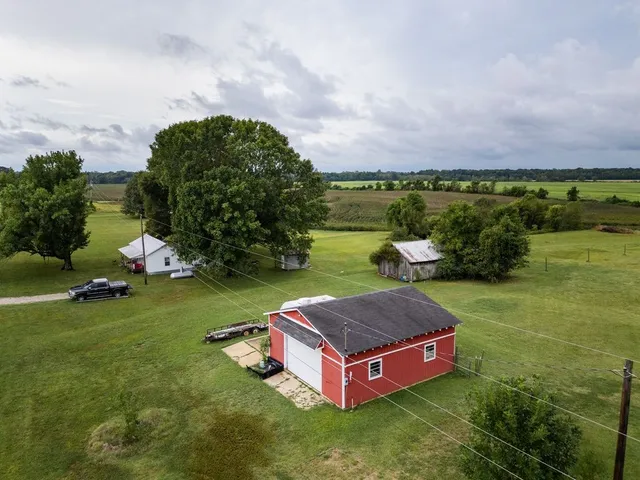 an aerial view of a house with swimming pool and garden