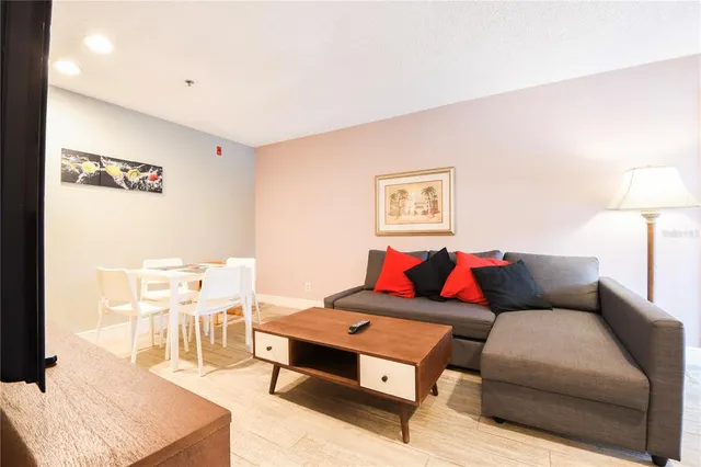 a living room with furniture and a lamp