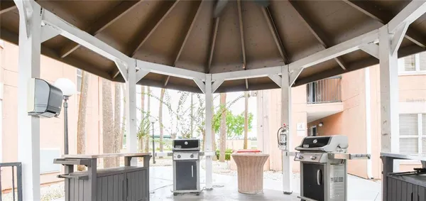 a kitchen with stainless steel appliances a large window and a chandelier