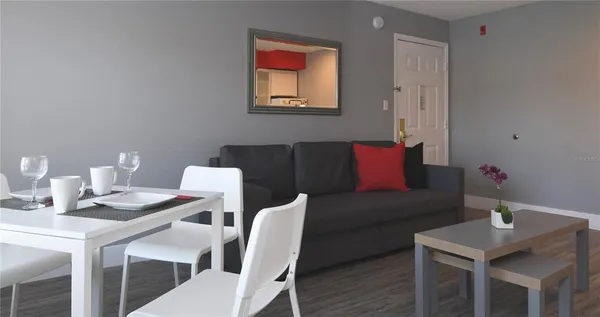 a view of a dining room with furniture and wooden floor