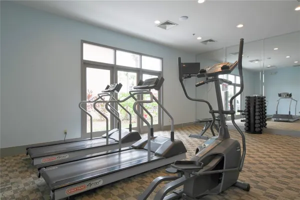 a room with gym equipment and large window
