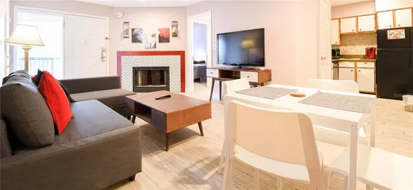 a living room with furniture a fireplace and a flat screen tv