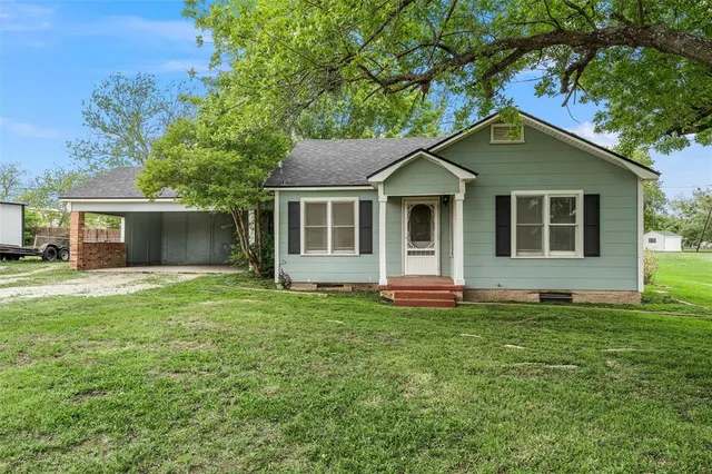 a house that has a tree in front of it